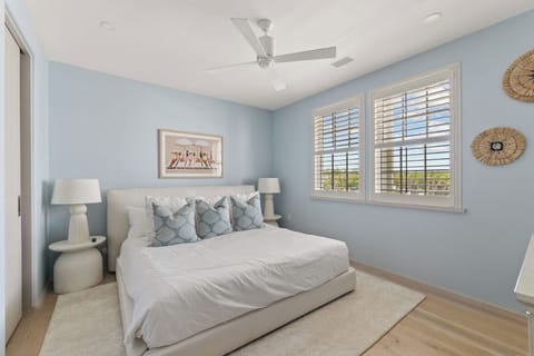 Drift off in a serene bedroom with soft coastal tones.