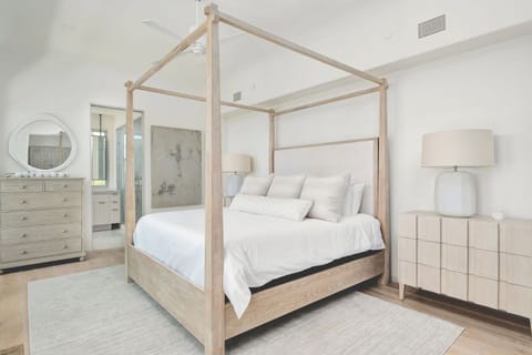 Drift into plush comfort in this serene, airy primary suite.