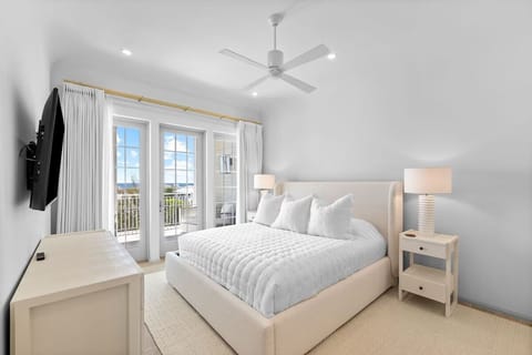 Unwind in crisp linens with balcony doors and sky views.