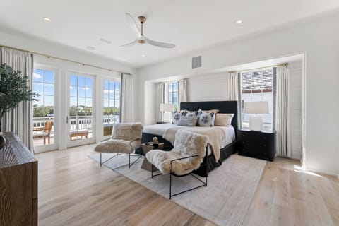 Wake up refreshed in the sunlit suite with balcony access.