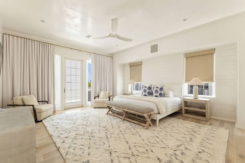 Unwind in the airy primary suite with cozy lounge chairs.