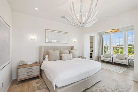 Unwind in a serene suite with plush bedding and bright views.