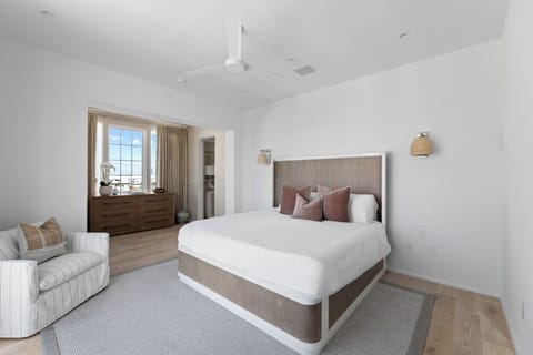 Drift off in crisp linens beneath a calming, airy palette.