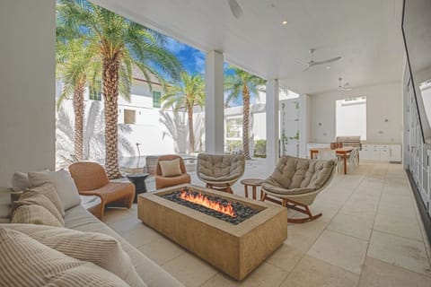 Linger by the outdoor fire table under tropical skies.