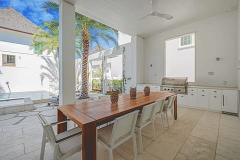 Dine alfresco beside the grill in breezy shaded comfort.