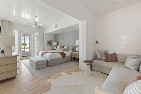 Unwind in a sunlit suite with cozy lounge seating.