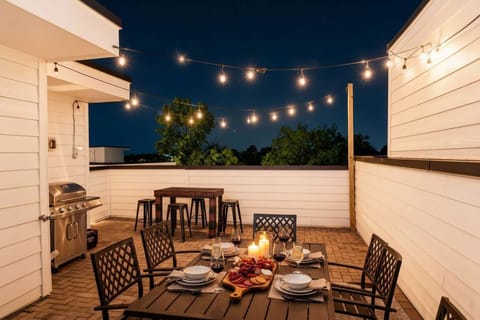 String lights and a tall bar table on the rooftop turn a Nashville night into the kind of story you'll replay all year. BBQ, toasts, and an open sky