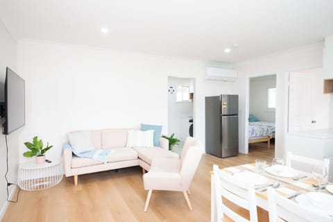 Airy open-plan lounge with comfy seating and abundant natural light.