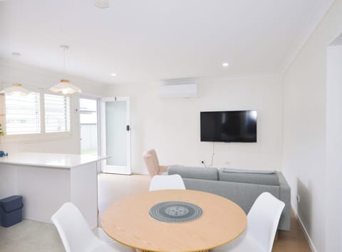 Cozy dining nook with round table and modern chairs, perfect for meals.