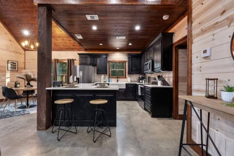 Step inside to an open-concept living space designed for hosting. The fully equipped kitchen features sleek black cabinetry, stainless appliances, and a massive island perfect for staging a family taco night or holiday feast. Whether you’re a gourmet cook