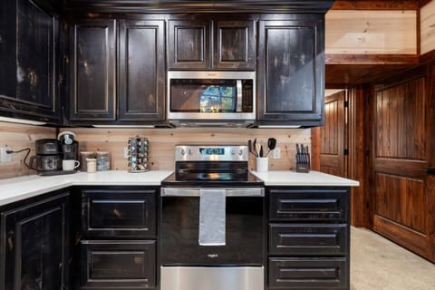 Fuel your adventures at our fully-stocked coffee station. Whether you`re brewing a fresh morning pot or preparing a family breakfast on the modern glass-top range, this luxury kitchen is designed for high-capacity hosting with high-end style.