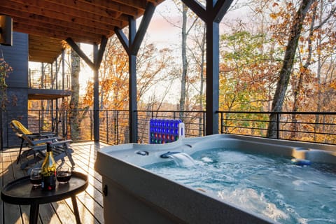 Balcony with hot tub, seating, and views.
