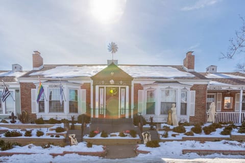 Historic brick exterior with charming entryway and seasonal wreath welcoming guests