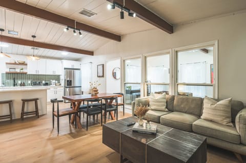 living room have huge glass panels & pop of greens 
