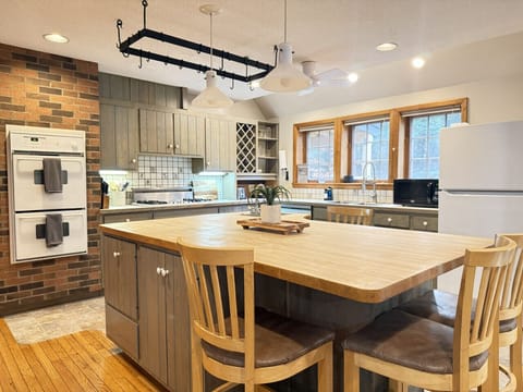 Spacious kitchen with a large central island and seating for four.