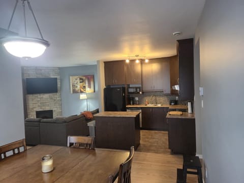 Open-concept dining, kitchen, and living area with modern finishes, perfect for gathering and relaxing.