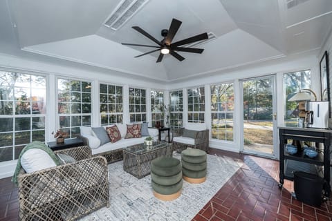 Enjoy slow mornings and relaxed evenings in this inviting sunroom, where wraparound windows, cozy seating, and peaceful views create a calming space to unwind and reconnect.
