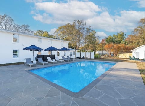 Lounge by the sparkling pool and soak in the peaceful surroundings, where shaded seating and open skies invite you to slow down, unwind, and enjoy every moment outdoors.
