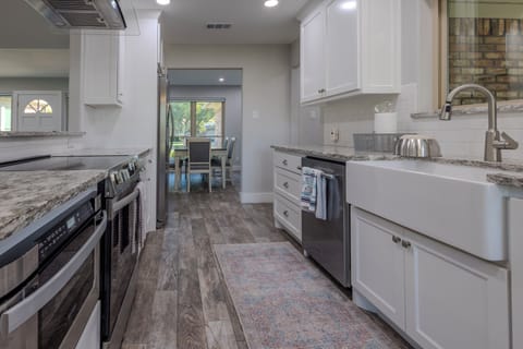 Beautifully remodeled kitchen opens to living and dining areas with lake views