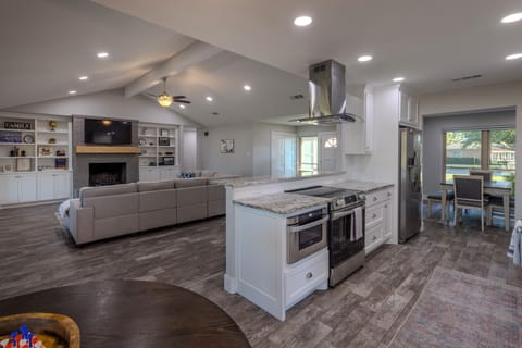 Beautifully remodeled kitchen opens to living and dining areas with lake views