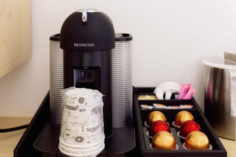 Start your morning right with a gourmet coffee experience featuring a sleek Nespresso machine and an array of delightful capsules.