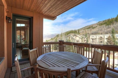Private balcony with seating and panoramic mountain views — ideal for coffee or après-ski relaxation.