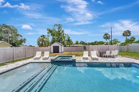 pool with sun shelf and hot tub