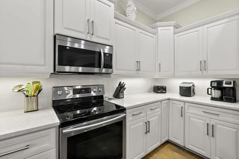 Fully stocked kitchen with stainless appliances and quartz counters