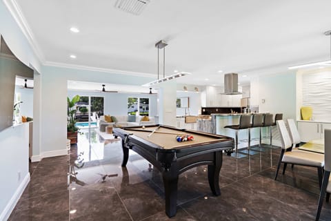 Who says you can’t multitask? Grab a snack, take your shot, and keep the fun rolling — this pool table by the kitchen means game night and snack night are always one and the same.