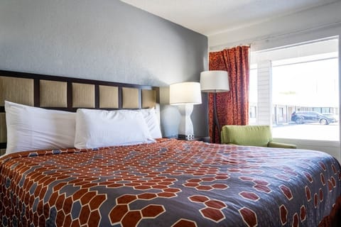 Wake up to daylight beside the king bed and reading lamp.