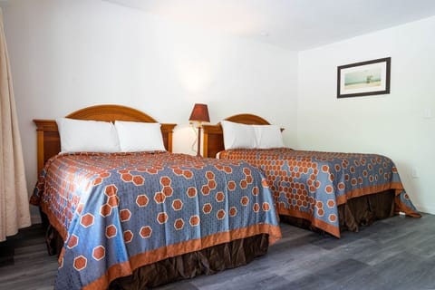 Settle into spacious comfort with two beds and soft lighting.