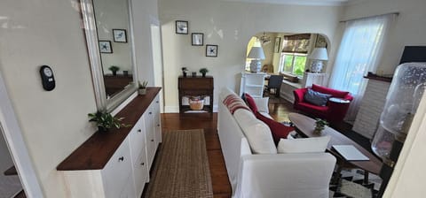 Main House Living Room has queen sleeper sofa, Roku TV, fireplace, shelves, fan