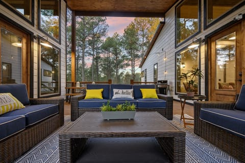 Your new favorite spot! This covered deck is a guest favorite because everyone can connect in one dreamy covered spot! The hot tub sits right here under full cover, so you can soak while the fireplace glows+ the game plays on the outdoor TV. 