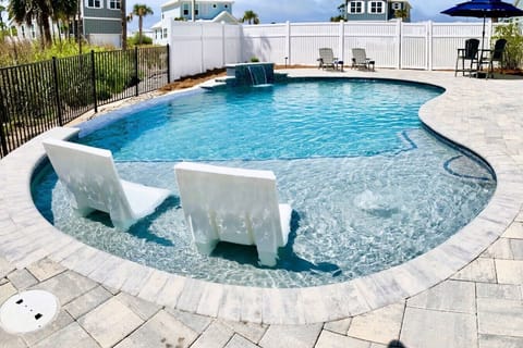 New private heated pool with shear water feature, bubblers, and loungers