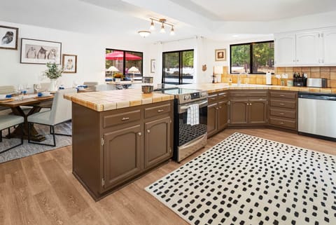 View from laundry area to dining table and outside patio