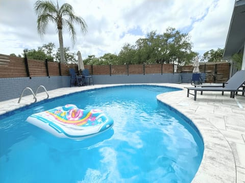 Resort-style pool with optional heating, sun loungers, umbrellas, and a privacy fence. Enjoy a basketball hoop, floats, and outdoor dining for poolside relaxation and fun all day