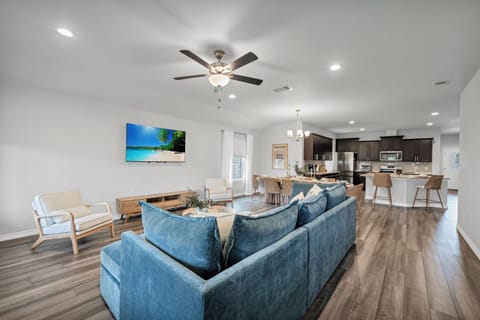 This spacious living room offers a bright and welcoming place to relax, complete with comfortable seating and modern decor.