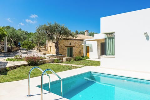 Private pool with sunbeds and umbrella for relaxing in the sun.