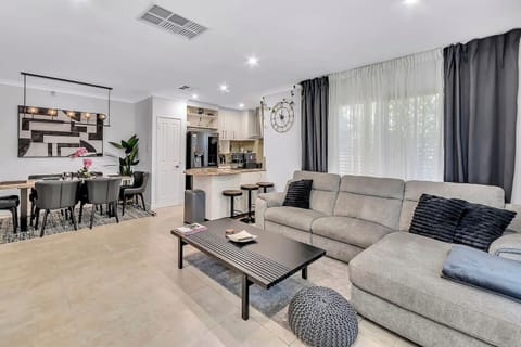 Enjoy effortless open-plan living that moves seamlessly from movie marathons to shared meals, all set against a backdrop of elegant design touches throughout.