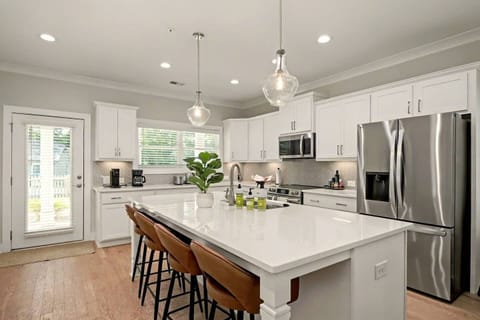 Chef-Ready Kitchen – Cook with ease using a stocked kitchen, electric stove, coffee station, and island seating for 4.