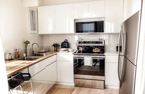 Full size kitchen with dishware, silverware and cooking essentals. Pots & Pans.