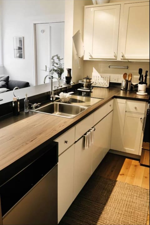 Large fully stocked kitchen with dishes, silverware, cooking ware.