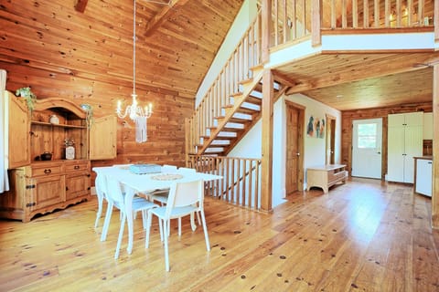 Dining area with chandelier and stairs leading up to the Cedar Loft bedroom.