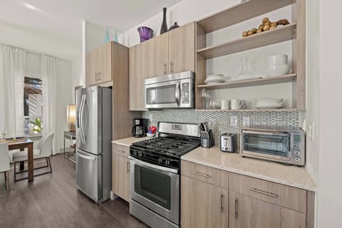 Modern gourmet kitchen featuring stainless steel appliances and high-end finishes.