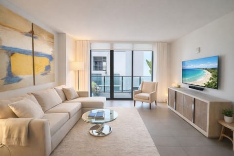 Stylish living room with a comfortable sofa and a smart TV enhanced by a soundbar.