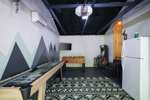 The Knotty Pine Cabin includes a garage game room with foosball & shuffleboard