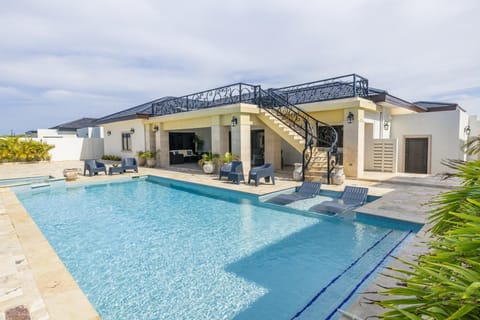 Dive into paradise! Our expansive, sparkling private pool is the centerpiece of your luxury vacation. With ample sun loungers and a large deck for all your outdoor activities, you'll want to spend every moment here.