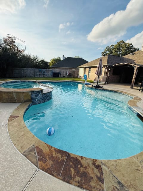 Pool and hot tub in private back yard. Pool is 6 ft deep with multiple ledge 