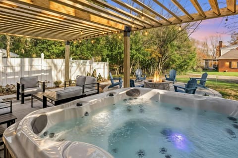 Enjoy a soothing soak in the hot tub, thoughtfully placed under a pergola with a tranquil yard setting that adds comfort and quiet to your stay.