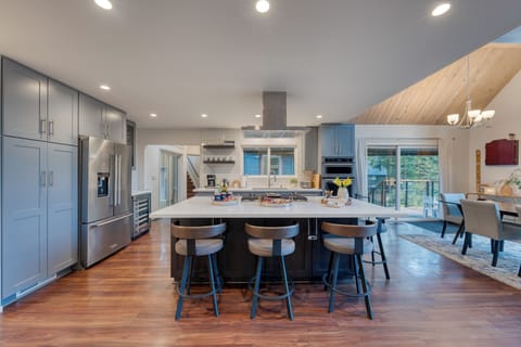 Modern chef’s kitchen with a spacious island, sleek appliances, and seating for the whole group to gather.